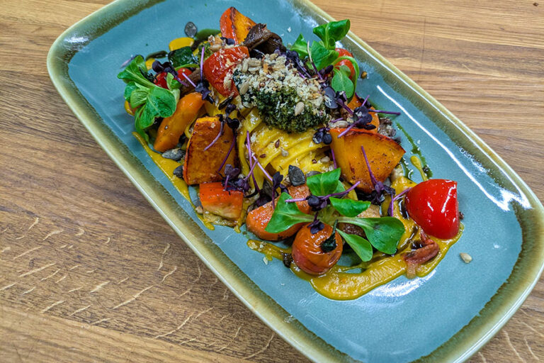 Cremige Kürbis-Pasta mit saisonalem Gemüse und Kräutern, serviert im Gasthof Reblitz in Nedensdorf.